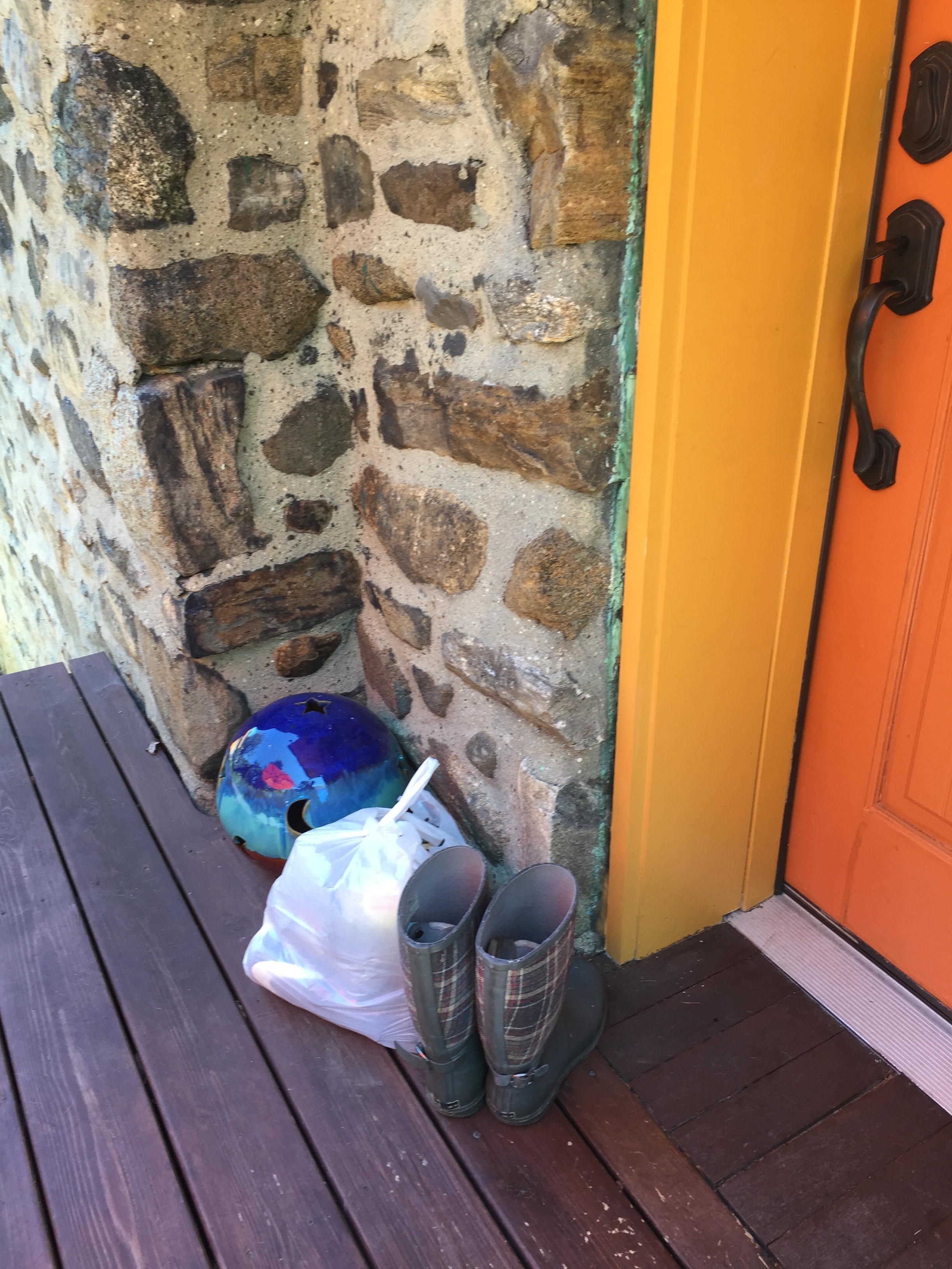 Boots and what-nots collect in the corner by the door.